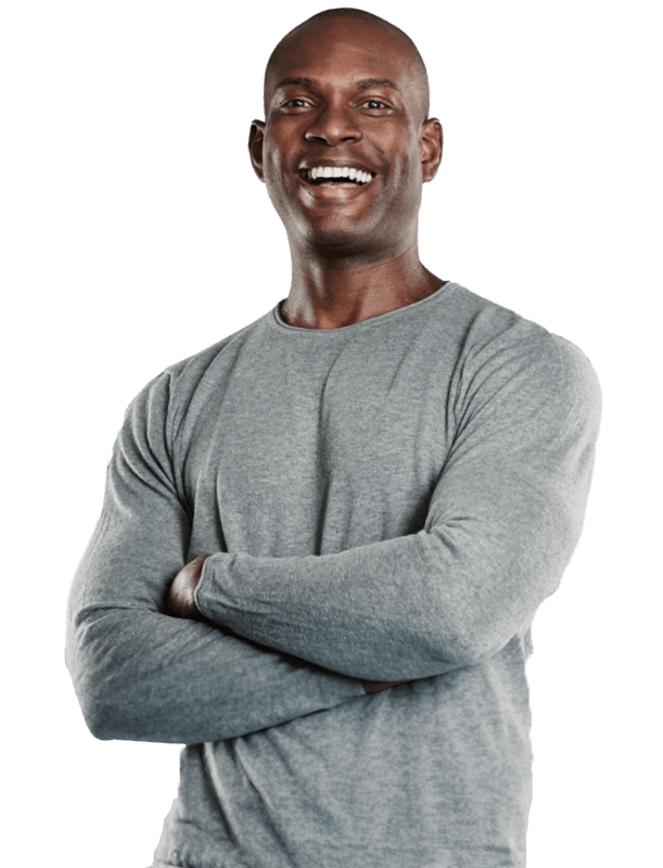 Middle-aged man smiling with arms crossed | Primary Care | All Island Medical