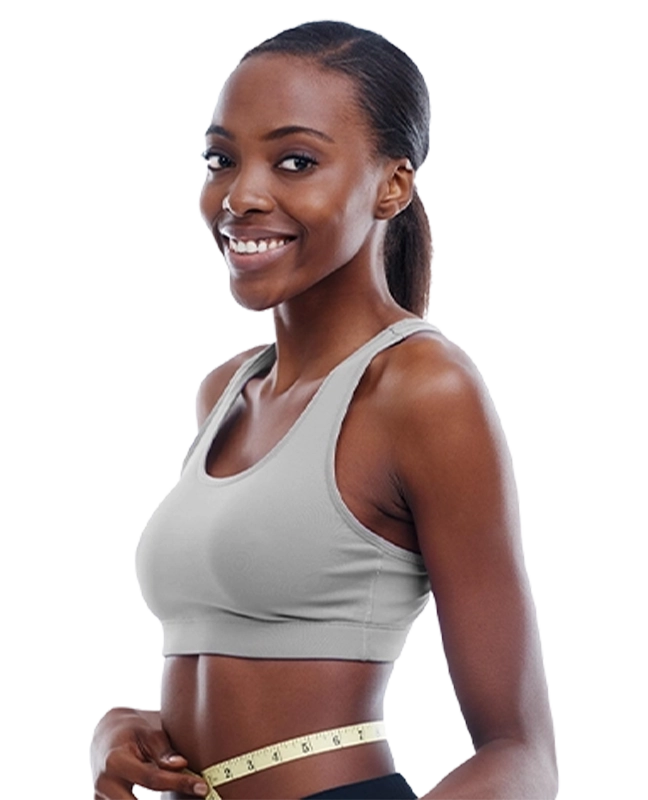 African American woman smiling while measuring her stomach with measuring tape | Weight Loss | All Island Medical